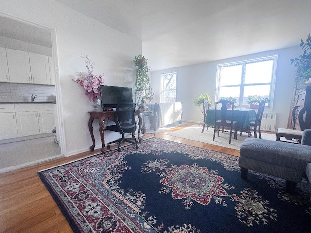 living area with light wood-style flooring and baseboards