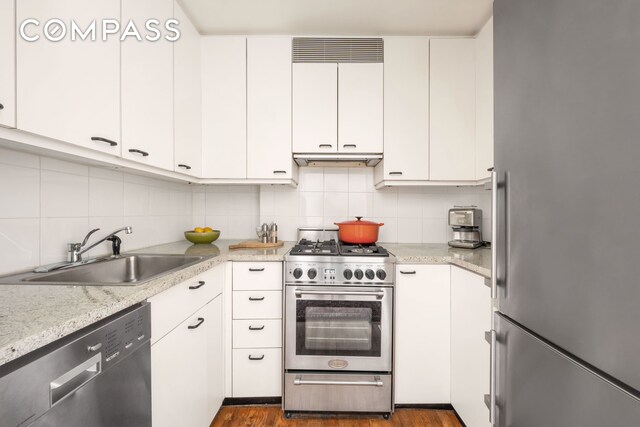 kitchen with white cabinetry, sink, tasteful backsplash, and appliances with stainless steel finishes