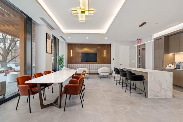 dining room with a raised ceiling