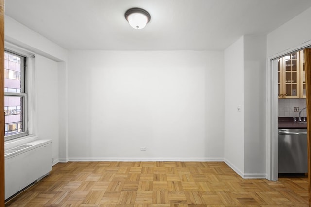 136 E 56th St Unit 9J, New York City, NY 10022 - unfurnished dining area featuring radiator heating unit and baseboards