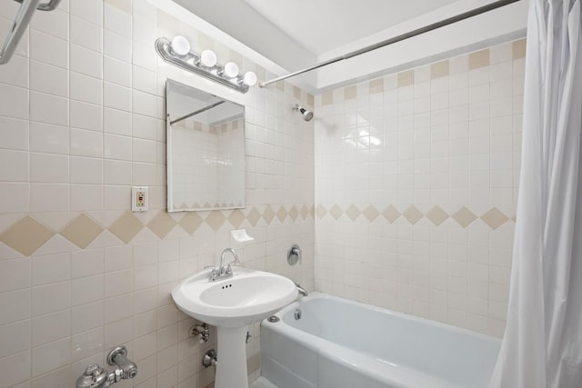 bathroom with shower / bath combination with curtain and tile walls