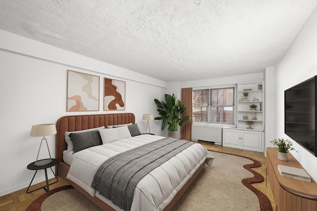 bedroom with radiator heating unit, baseboards, and a textured ceiling