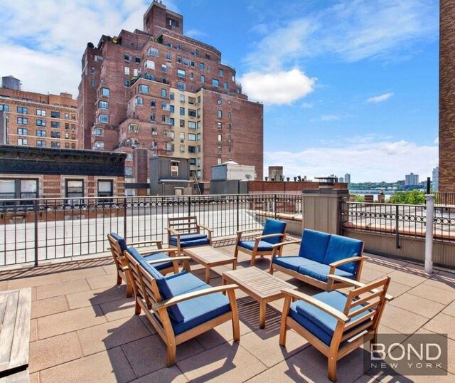 view of patio / terrace with a balcony and an outdoor living space