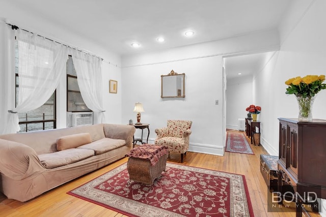 living room featuring cooling unit and light hardwood / wood-style floors