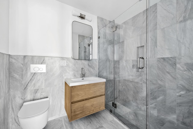 bathroom featuring toilet, tile walls, a stall shower, and vanity