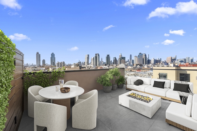 view of patio with an outdoor living space with a fire pit, a view of city, and outdoor dining space