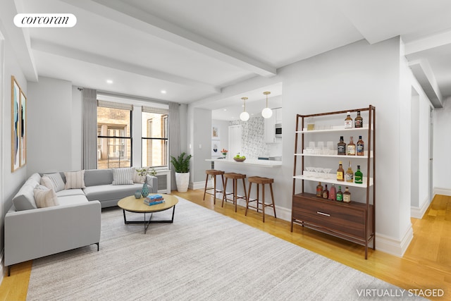 living area featuring wood finished floors, recessed lighting, baseboards, and beamed ceiling