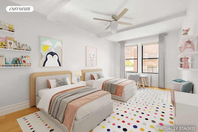 bedroom featuring beamed ceiling, wood finished floors, baseboards, radiator, and ceiling fan