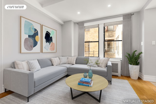 living area with wood finished floors, recessed lighting, and baseboards