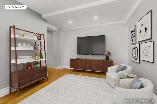 living room featuring recessed lighting, wood finished floors, visible vents, and baseboards