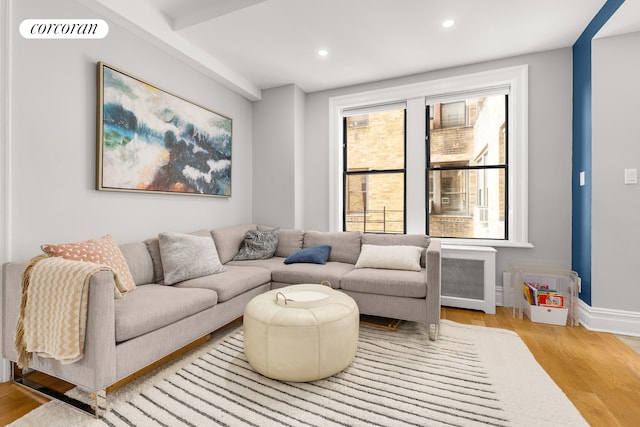 living room featuring light wood-style flooring, recessed lighting, and baseboards