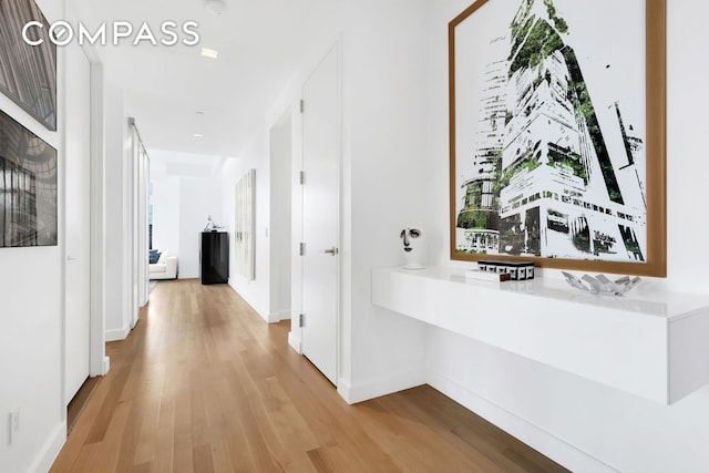 corridor with light hardwood / wood-style flooring