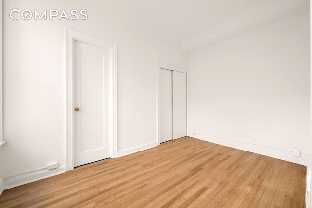 unfurnished bedroom featuring baseboards and light wood-style flooring