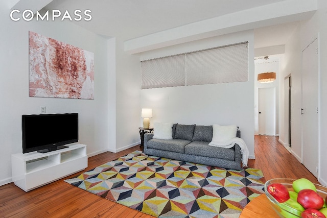 living room with baseboards and wood finished floors