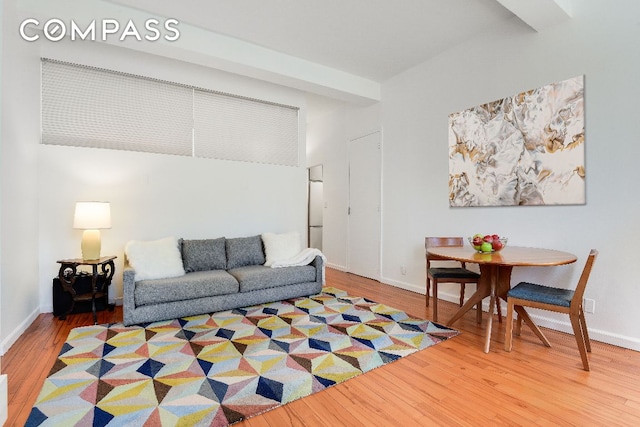 living room with beam ceiling and wood-type flooring