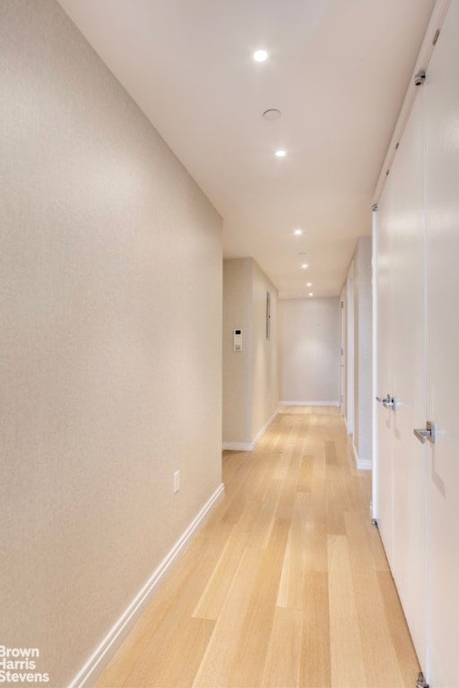 hallway with light hardwood / wood-style flooring