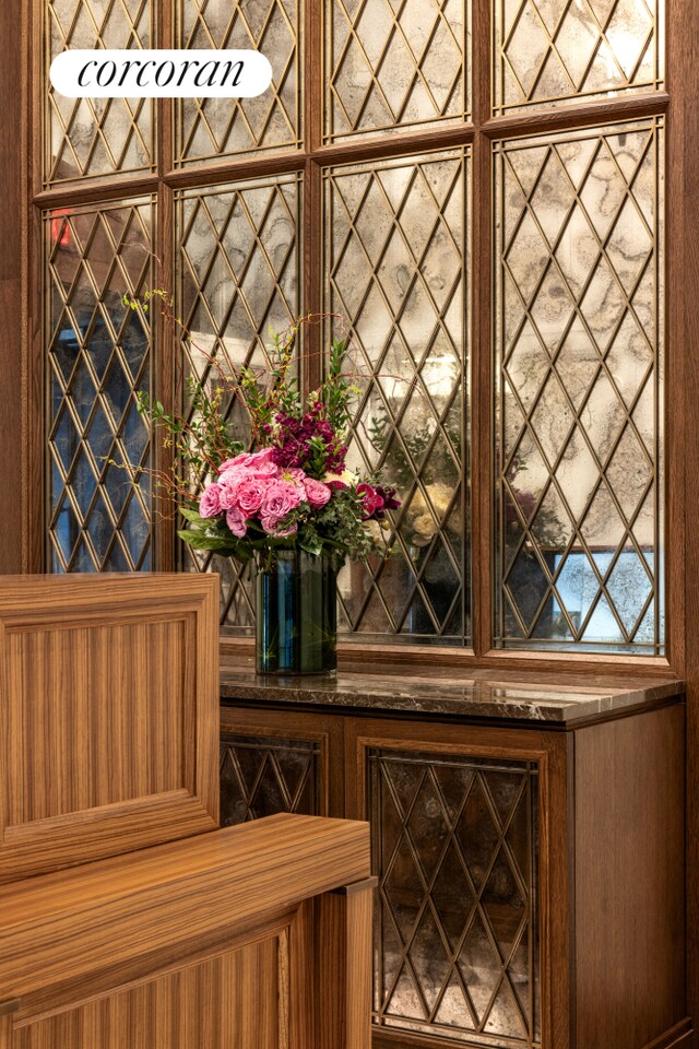 dining space with wood-type flooring, a water view, plenty of natural light, and a notable chandelier