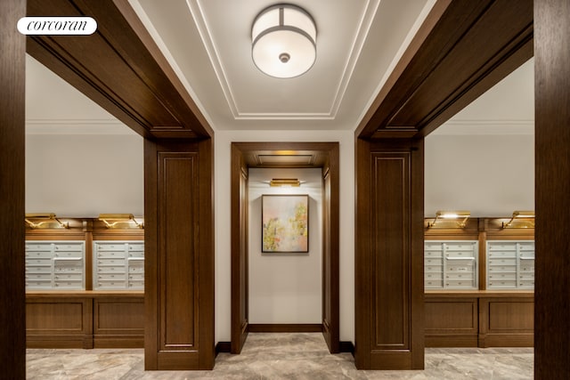 hall with baseboards, visible vents, and mail area