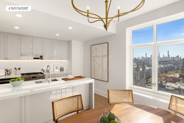 dining room featuring baseboards, visible vents, a view of city, a notable chandelier, and recessed lighting