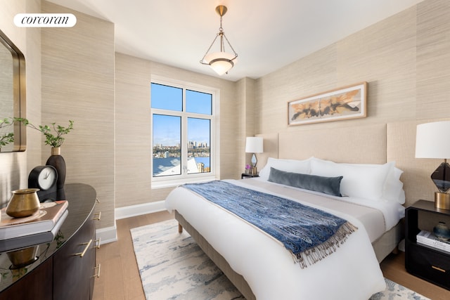 bedroom featuring baseboards and wood finished floors