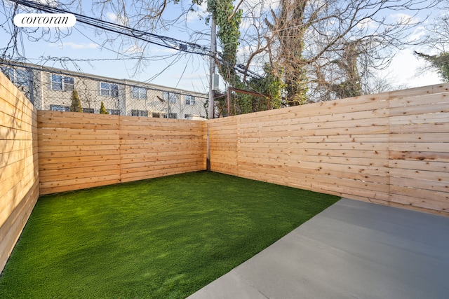 view of yard with a fenced backyard