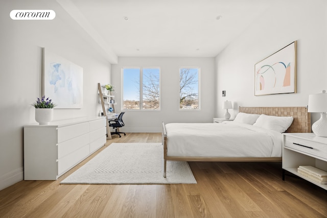 bedroom with visible vents, baseboards, and light wood-style flooring