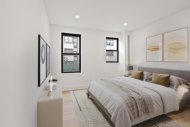 bedroom featuring recessed lighting, baseboards, and light wood finished floors