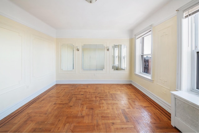 empty room with baseboards and radiator heating unit