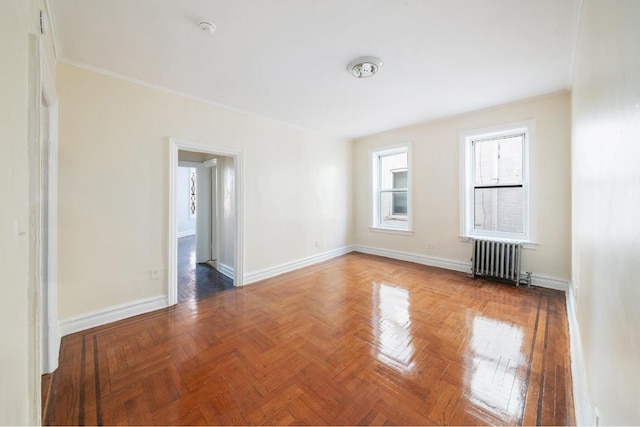 empty room with parquet flooring and radiator