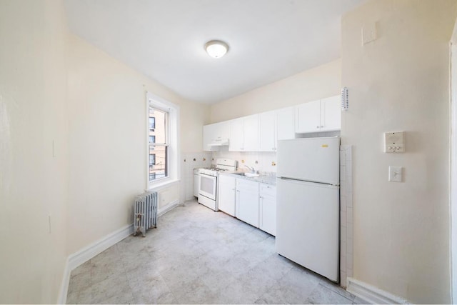 kitchen featuring sink, white appliances, radiator heating unit, and white cabinets