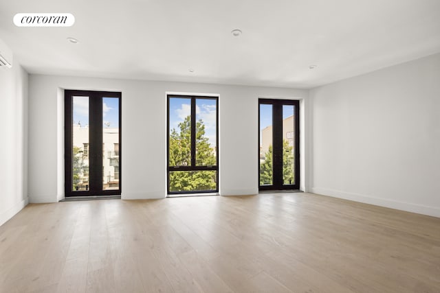 unfurnished room with light wood-style flooring, visible vents, baseboards, and recessed lighting