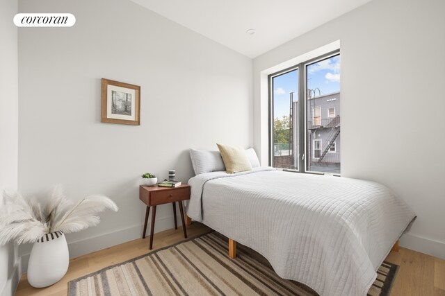 bedroom featuring lofted ceiling and hardwood / wood-style floors