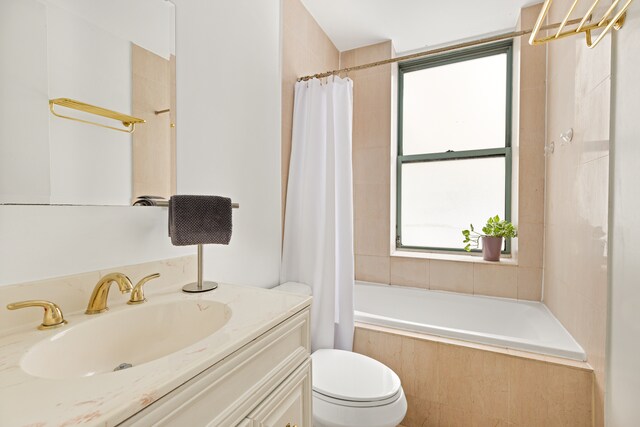 full bathroom with vanity, shower / bath combo, and toilet