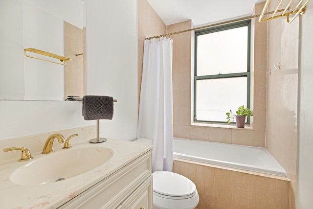 bathroom with tiled shower / bath, toilet, and vanity