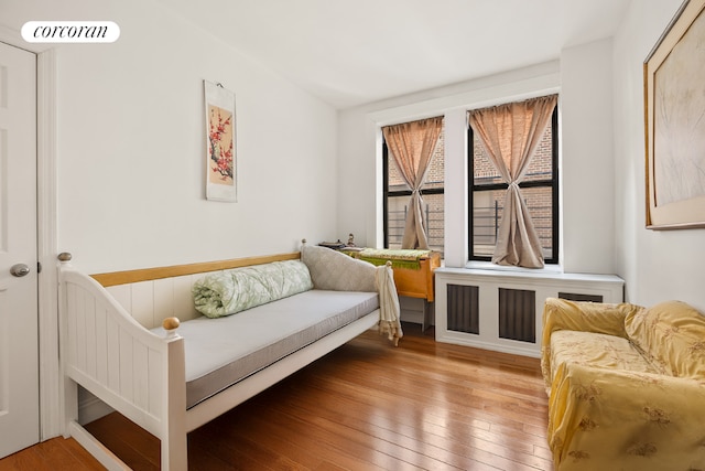 sitting room featuring hardwood / wood-style flooring and radiator heating unit