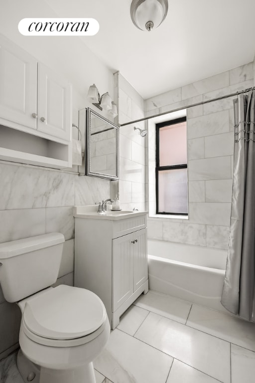 full bathroom featuring tile walls, vanity, toilet, and shower / bath combo with shower curtain