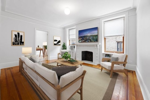 living room with ornamental molding and dark hardwood / wood-style flooring