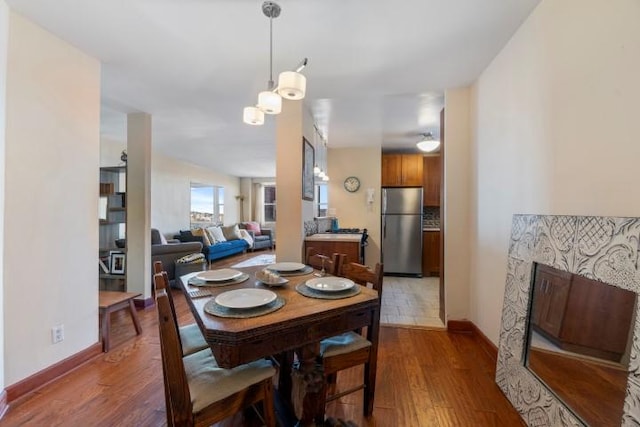 dining area featuring baseboards and wood finished floors