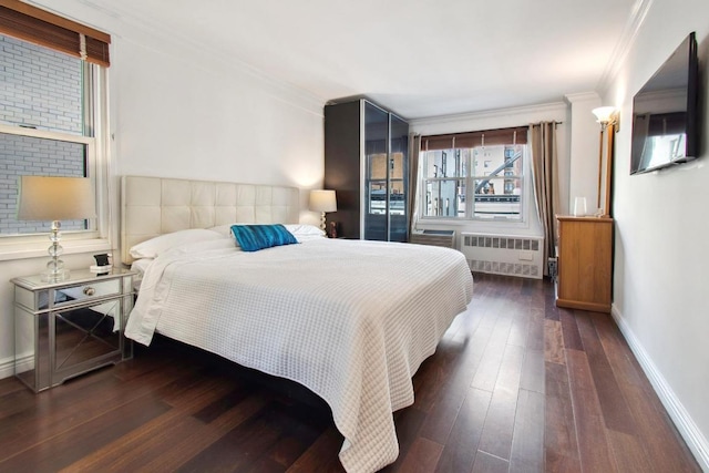 bedroom featuring ornamental molding, radiator heating unit, and dark hardwood / wood-style flooring