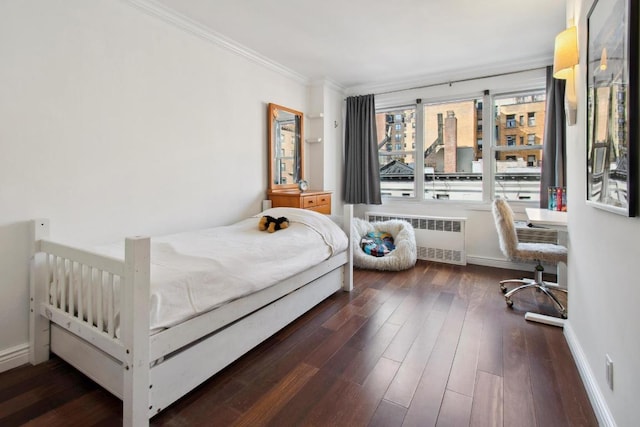 bedroom featuring dark hardwood / wood-style flooring, radiator heating unit, and ornamental molding