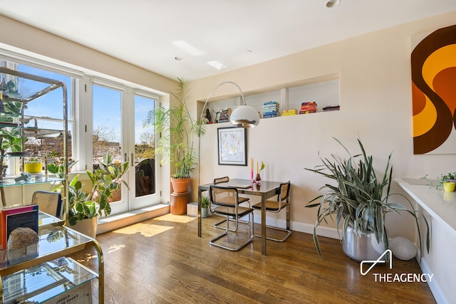 dining area featuring french doors, baseboards, and wood finished floors