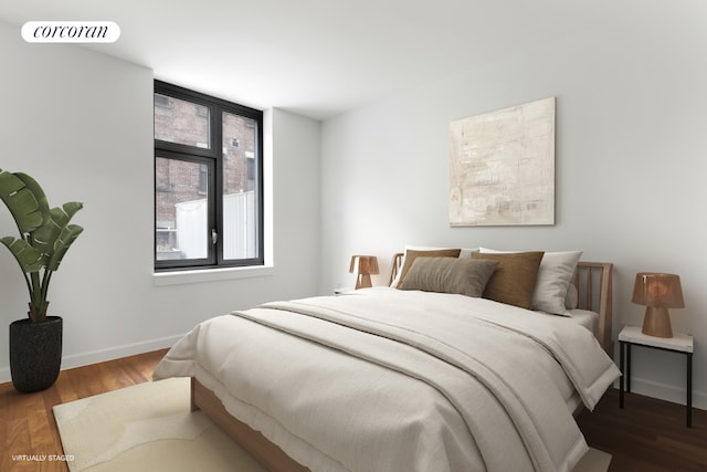 bedroom with wood finished floors, visible vents, and baseboards