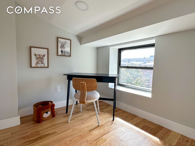 home office with vaulted ceiling, baseboards, and wood finished floors