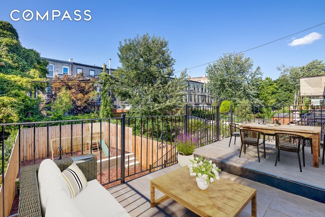 balcony featuring outdoor dining space and a patio area