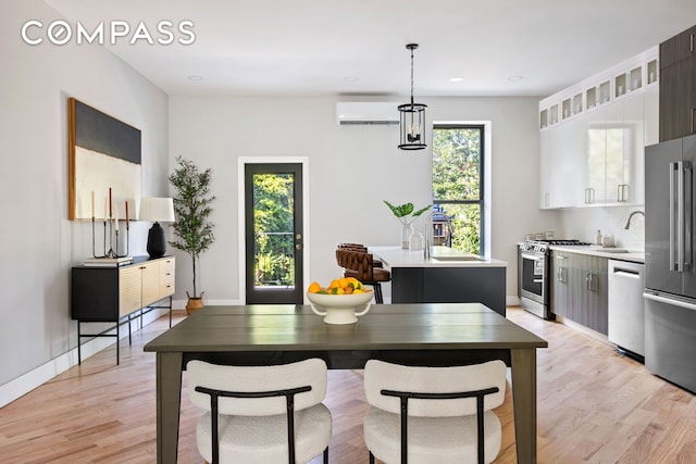 dining area with recessed lighting, light wood-style flooring, baseboards, and a wall mounted AC