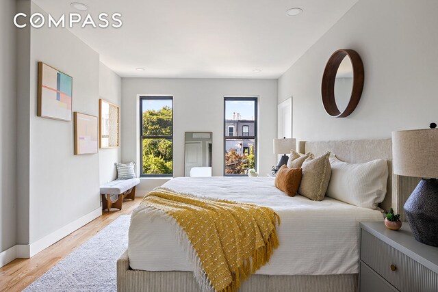 bedroom featuring light wood-style floors and baseboards