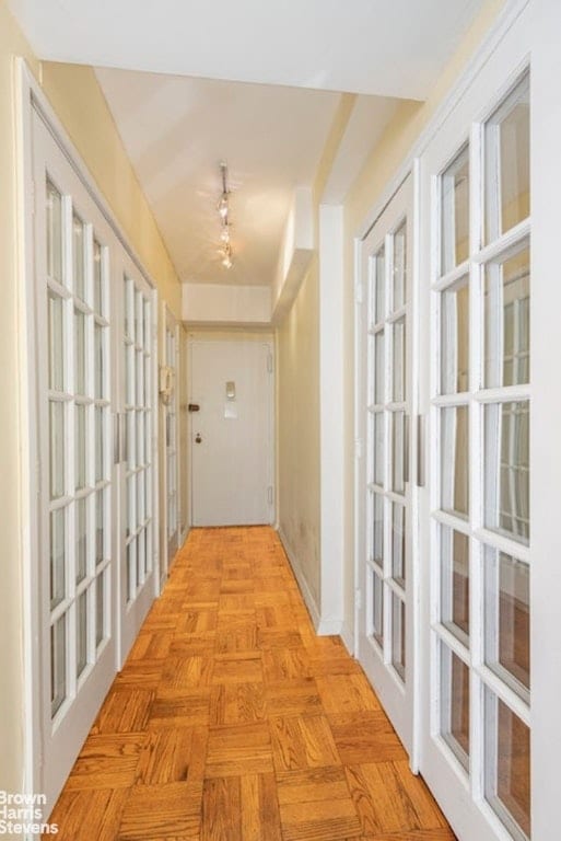 hallway featuring light parquet flooring and french doors