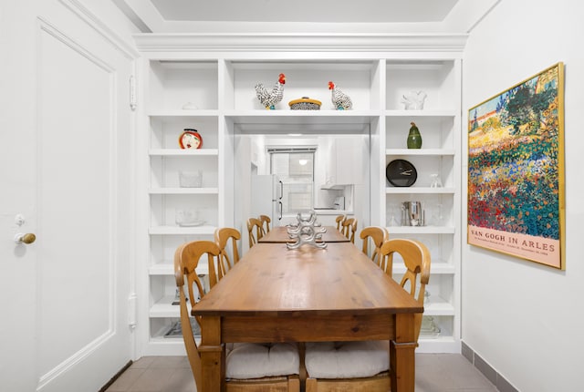 tiled dining room featuring built in features