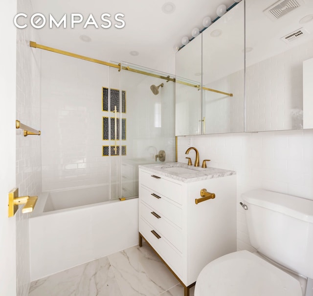 bathroom featuring marble finish floor, vanity, shower / tub combination, and visible vents