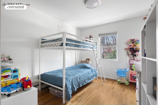 bedroom with baseboards and wood finished floors